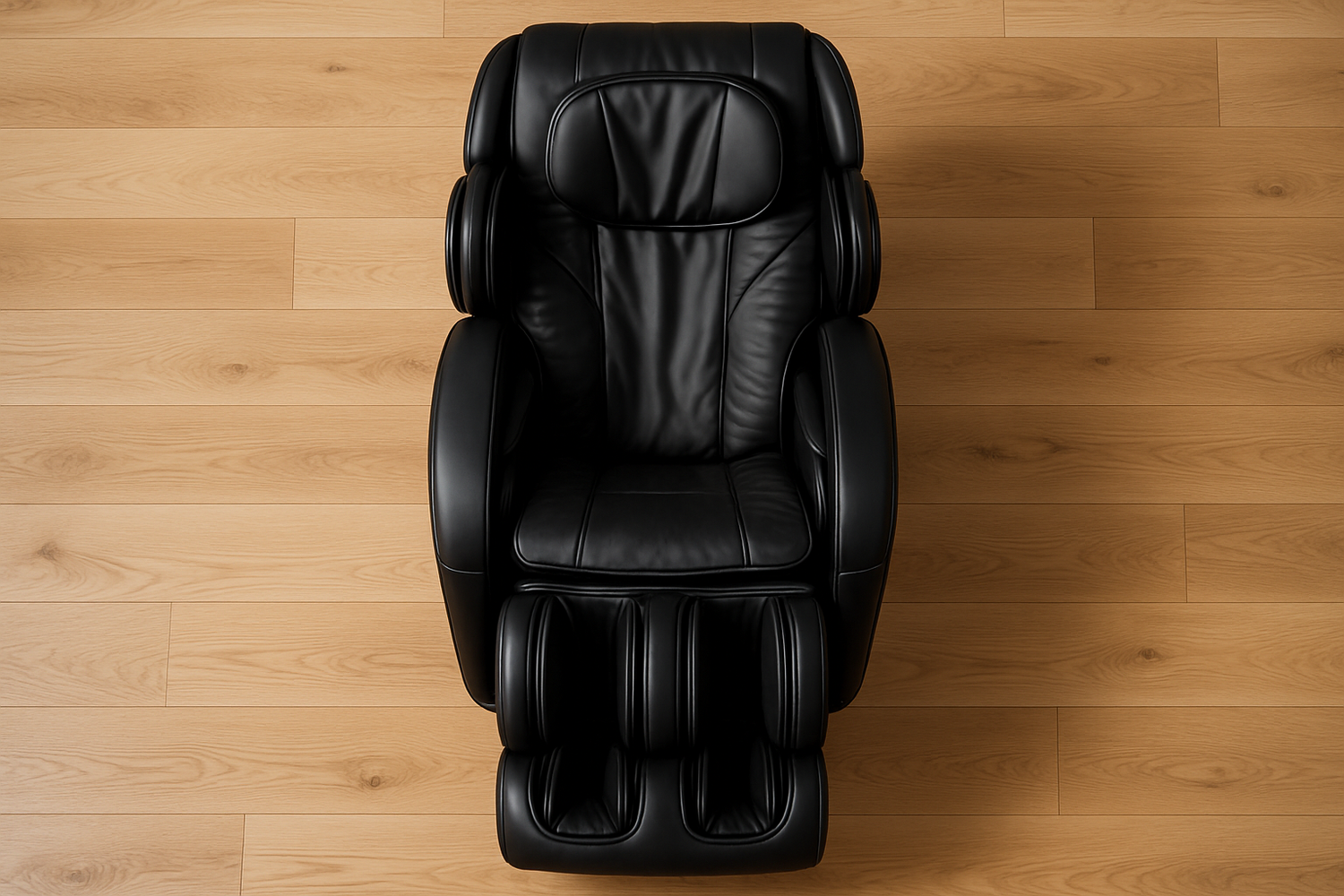 Generate me an image of a black luxurious high end massage chair fully reclined and viewed from the direct top with light oak wood floors as the background.